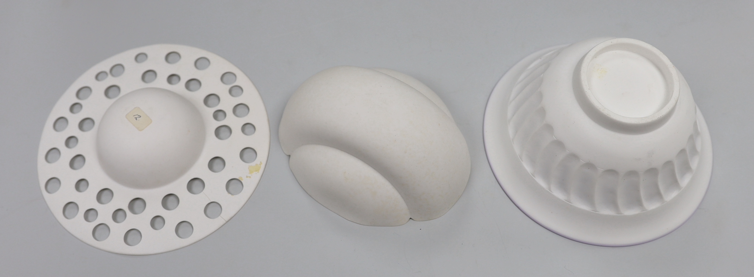 Three bone china studio bowls, one with pierced decoration, the largest 14.5cm in diameter